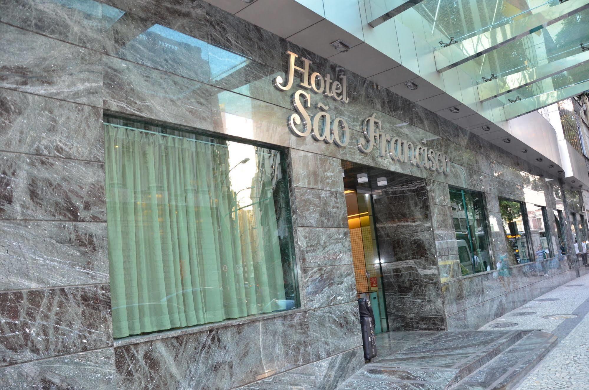 Hotel Atlantico Tower Рио де Жанейро Екстериор снимка The photo shows the exterior of a hotel named "Hotel São Francisco." The facade is made of marble, giving it an elegant appearance, and large glass windows are visible, likely allowing natural light to enter the interior. There are light green curtai